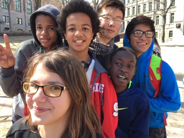 Six teenagers are taking a pose looking at the camera during their educational tour in Montreal